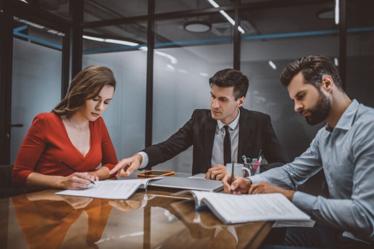 Lawyer advising couple on legal paperwork