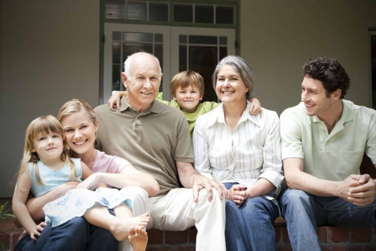 Three-generation family sitting together on terrace