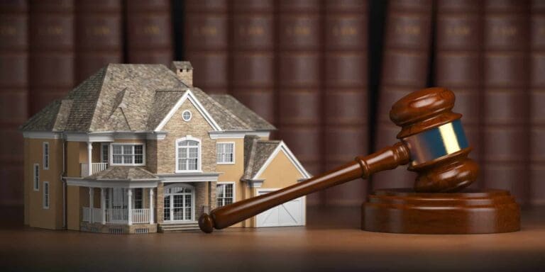 Gavel, law books, and house model representing real estate law