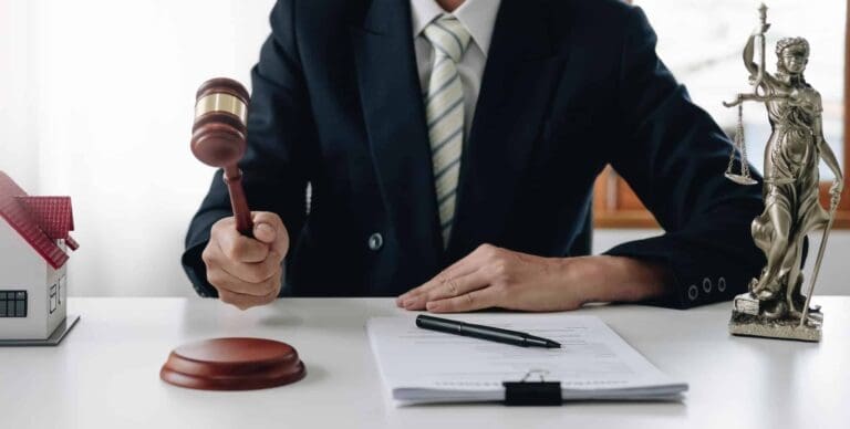 Judge holding gavel with justice scales in background